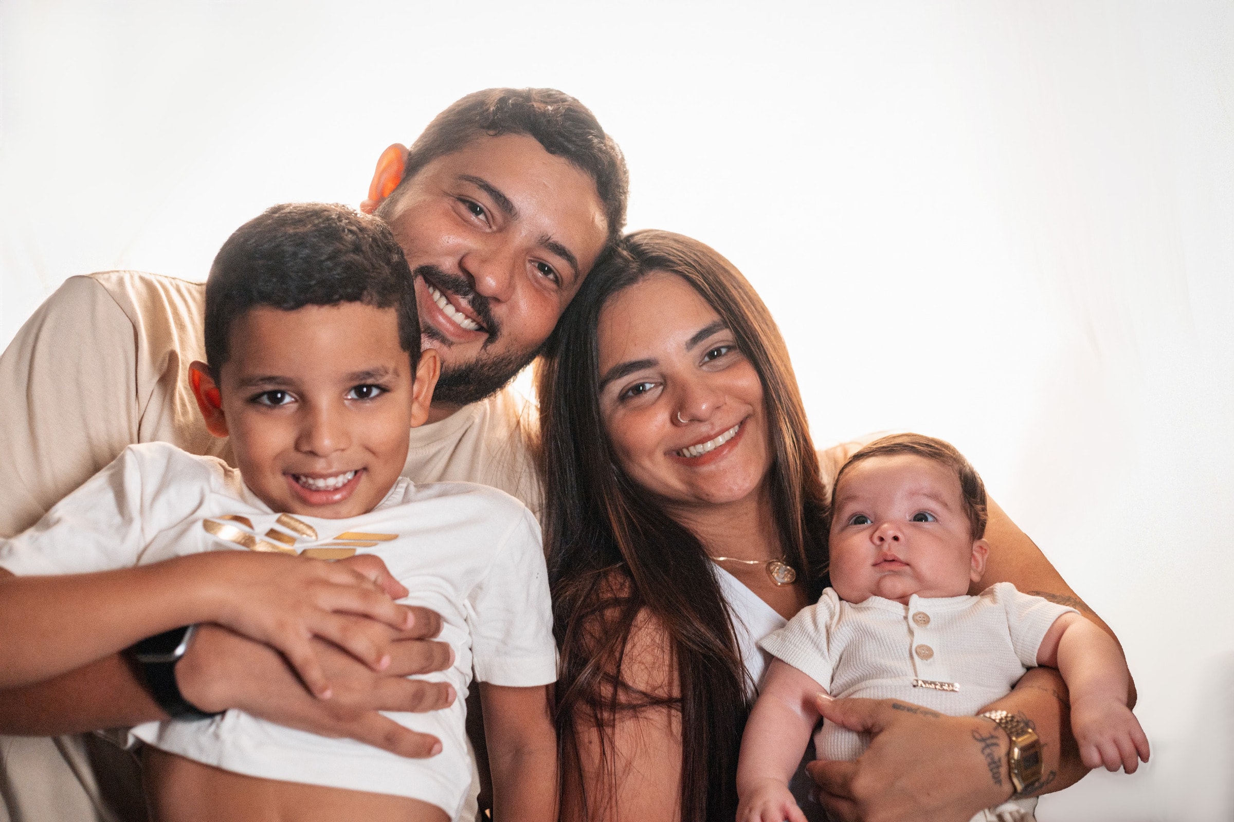 A family of four smiling together